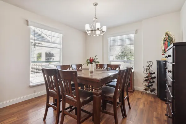 a view of a dining room with furniture window and wooden floor