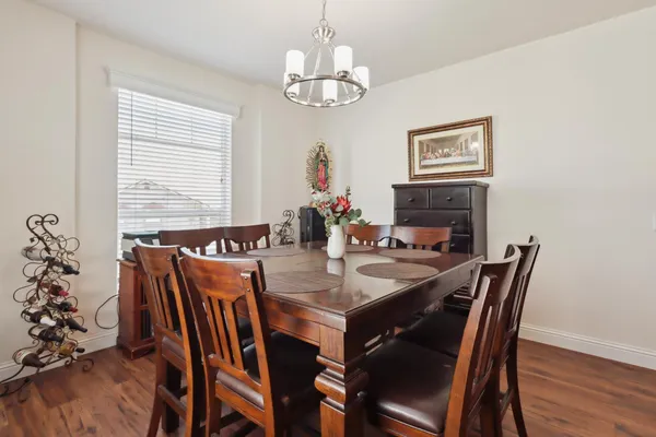 a view of a dining room with furniture wooden floor and chandelier