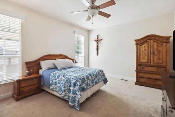 a bedroom with two beds and painting on the wall