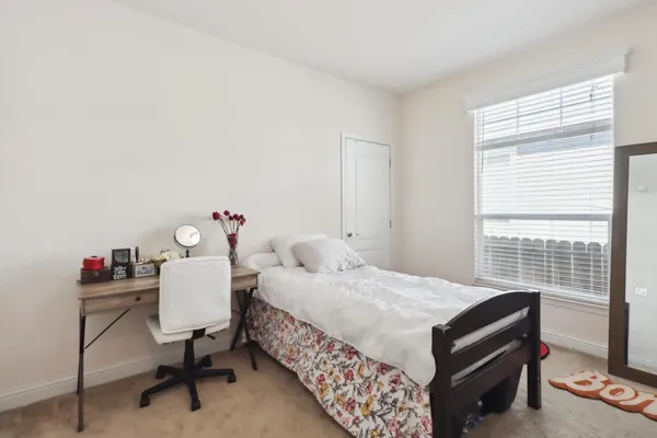 a bedroom with a bed and a table in it