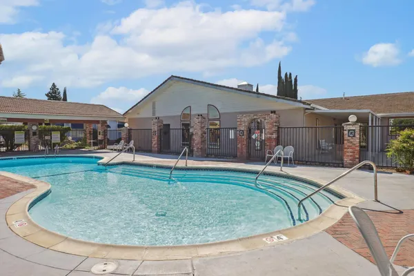 a swimming pool with outdoor seating yard and barbeque oven