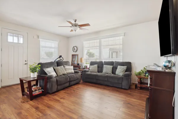 a living room with furniture and a flat screen tv