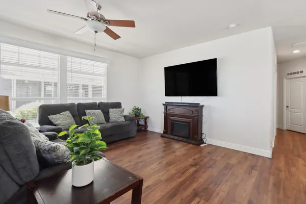 a living room with furniture a fireplace and a flat screen tv
