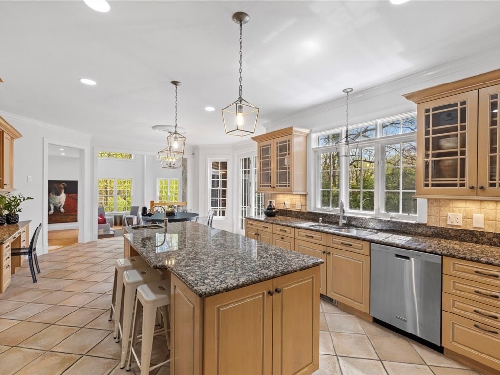 20 Laura Road Newton, MA 02468 - Photo 11 of 42 a kitchen with granite countertop sink stove and dining table