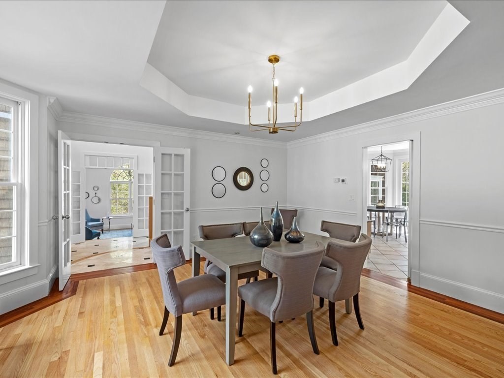 20 Laura Road Newton, MA 02468 - Photo 13 of 42 a view of a dining room with furniture wooden floor and chandelier