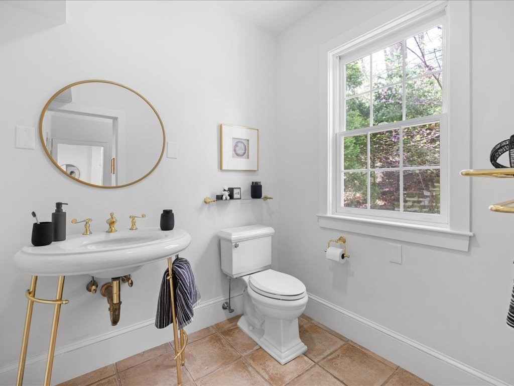20 Laura Road Newton, MA 02468 - Photo 15 of 42 a bathroom with a toilet a sink a mirror and a window