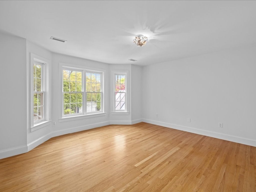 20 Laura Road Newton, MA 02468 - Photo 27 of 42 a view of an empty room with wooden floor and a window