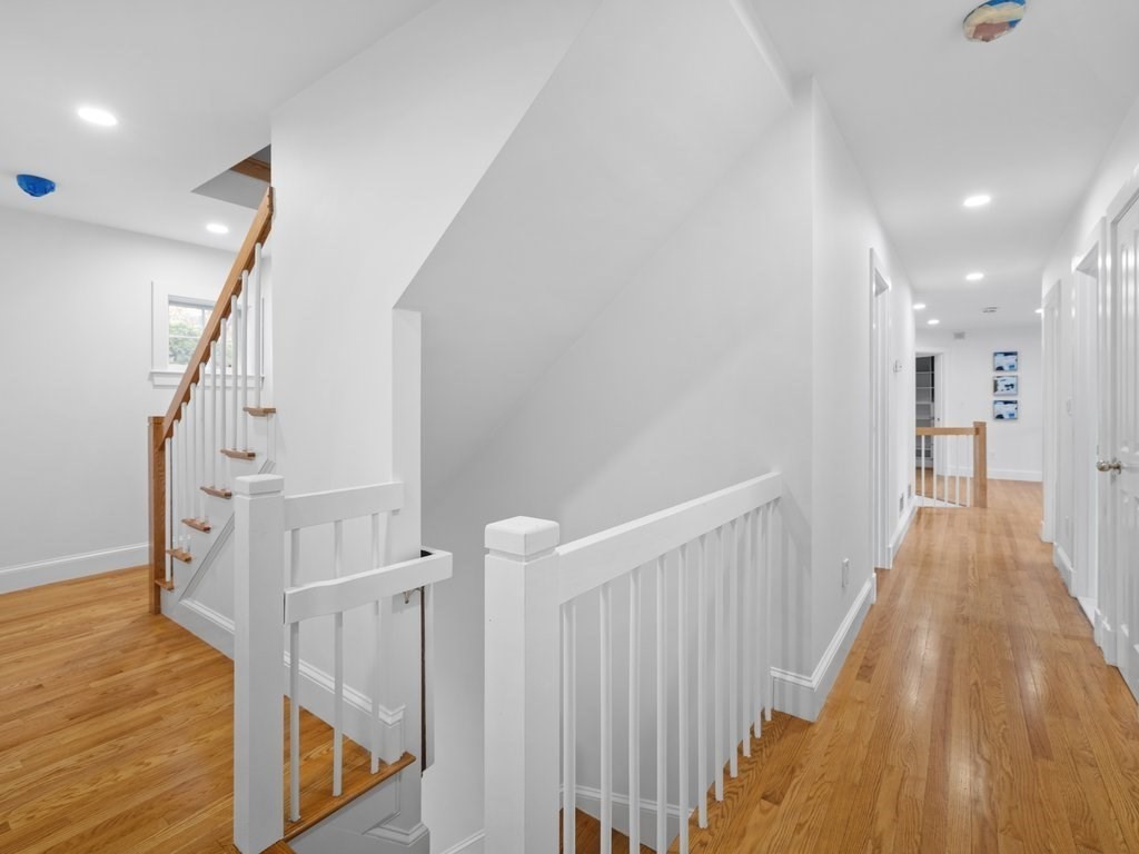 20 Laura Road Newton, MA 02468 - Photo 31 of 42 a view of a hallway with wooden floor and staircase