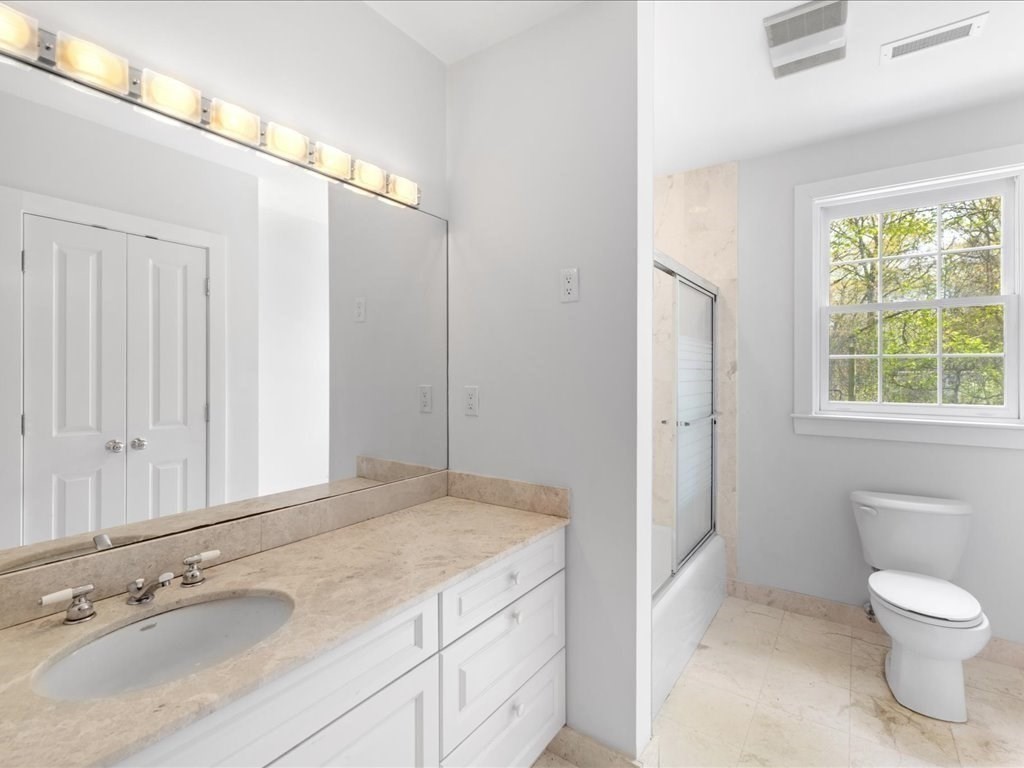 20 Laura Road Newton, MA 02468 - Photo 38 of 42 a bathroom with a granite countertop sink a toilet a mirror and window