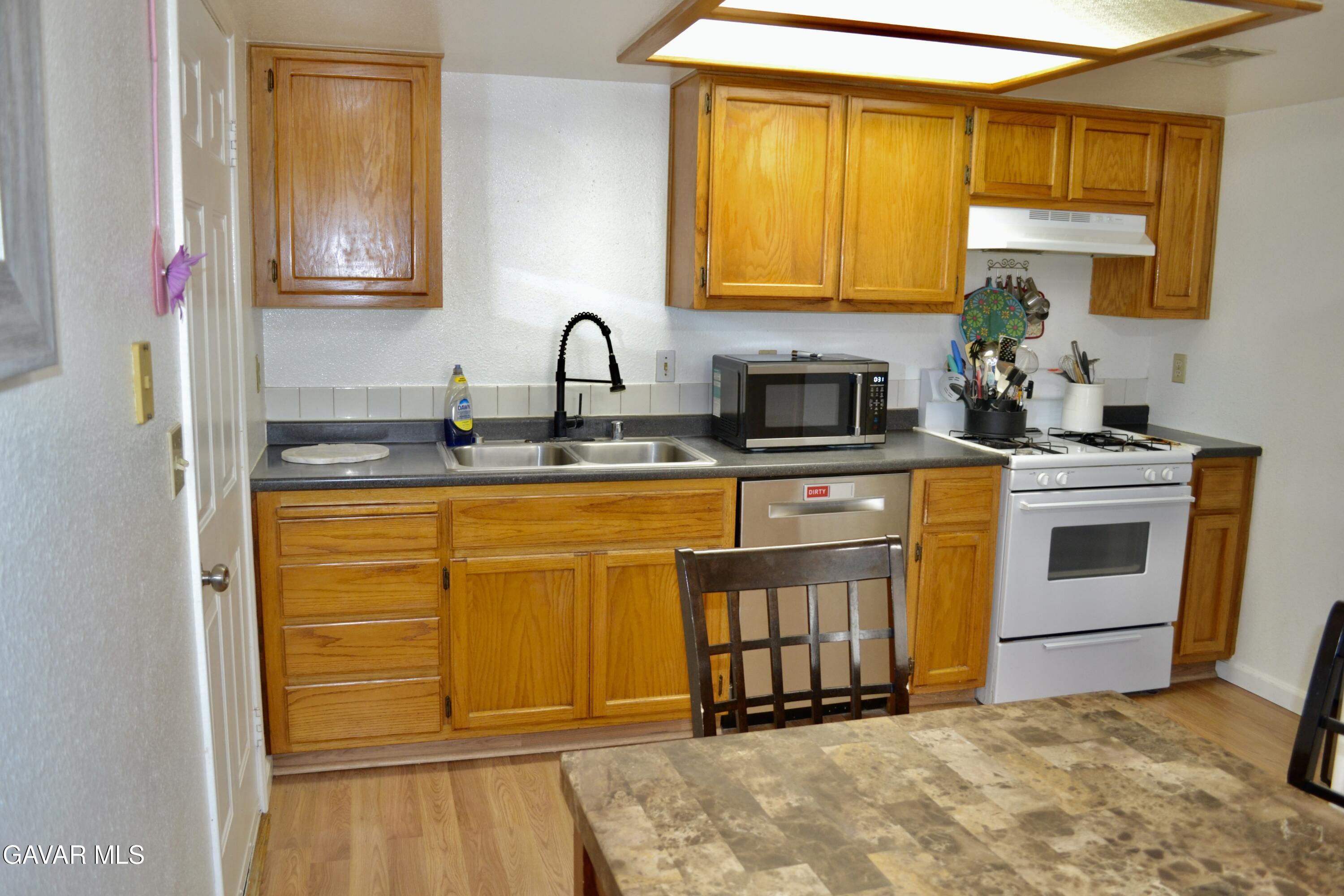 809 South Sunset Street Ridgecrest, CA 93555 - Photo 2 of 21 a kitchen with stainless steel appliances granite countertop a sink stove and cabinets
