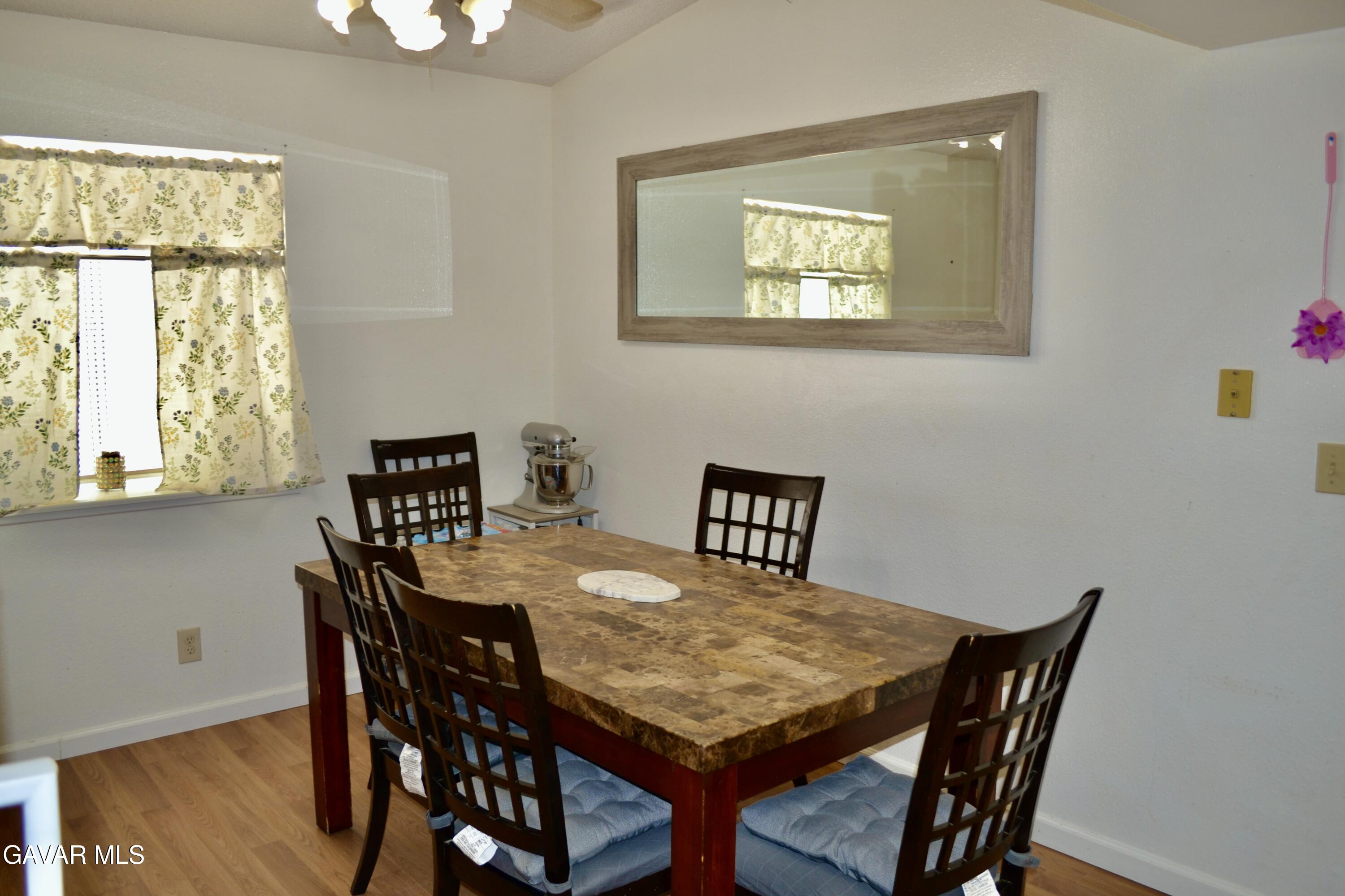 809 South Sunset Street Ridgecrest, CA 93555 - Photo 3 of 21 a view of a dining room with furniture and wooden floor