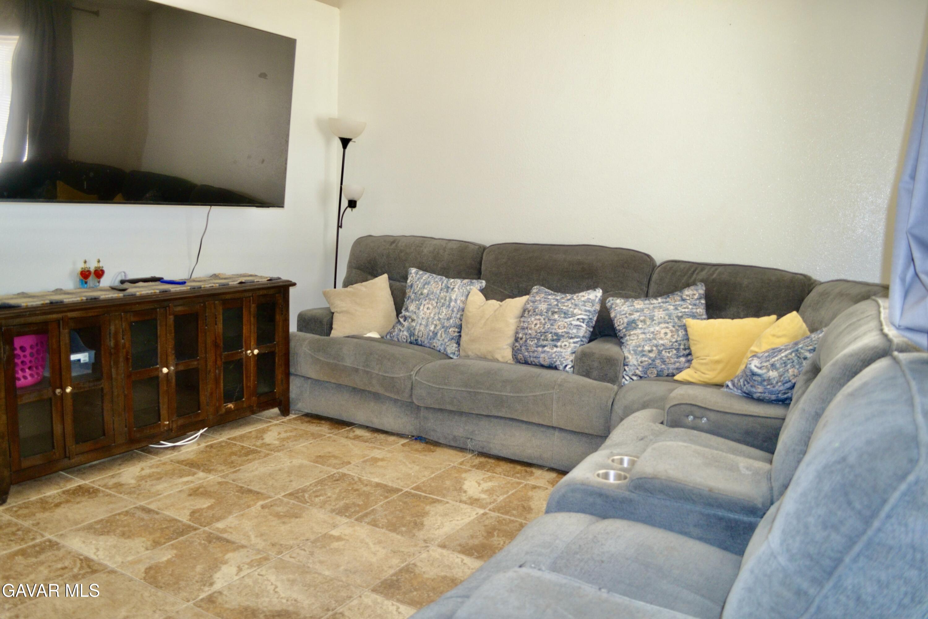 809 South Sunset Street Ridgecrest, CA 93555 - Photo 4 of 21 a living room with furniture and a flat screen tv