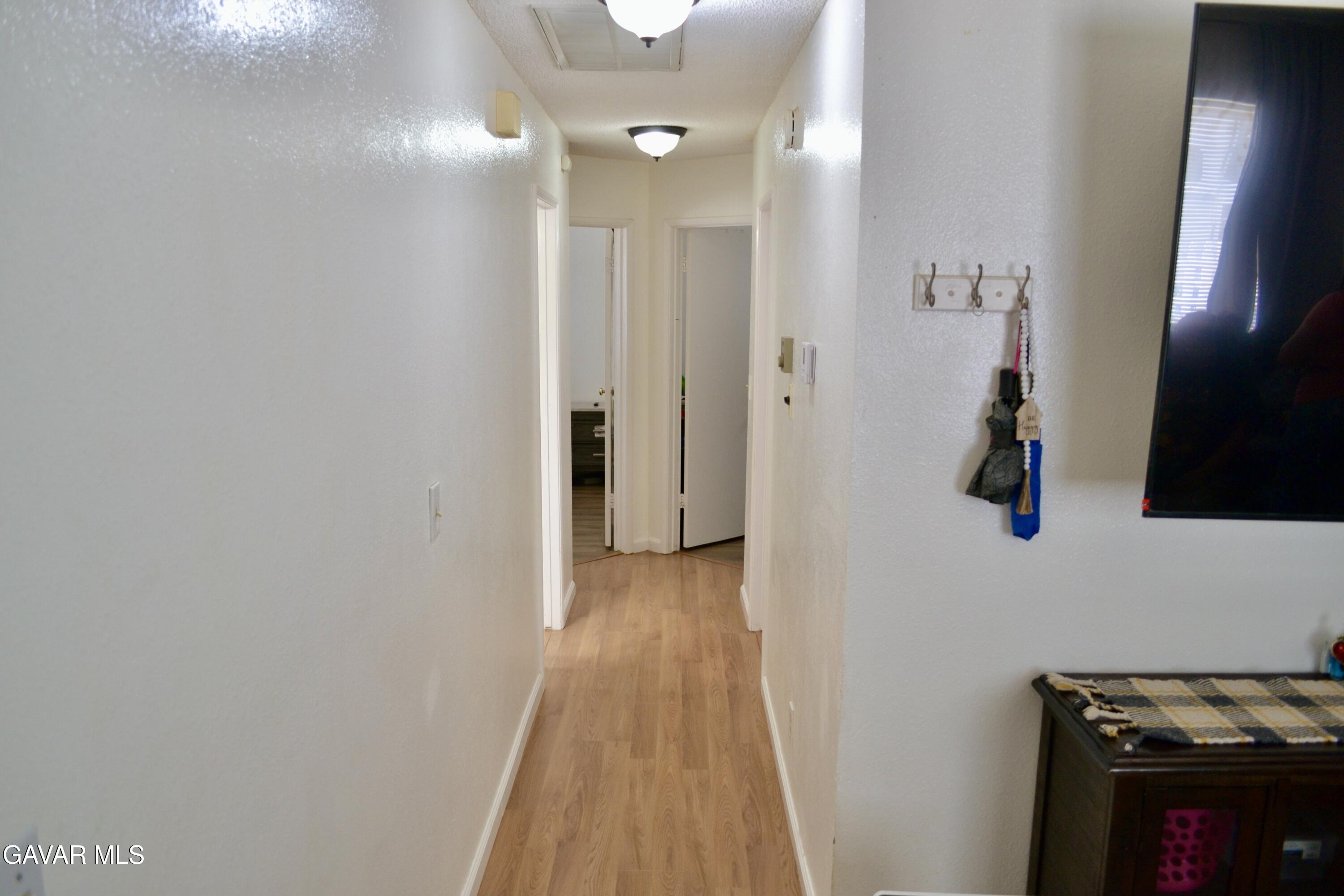 809 South Sunset Street Ridgecrest, CA 93555 - Photo 5 of 21 a view of a hallway with wooden floor