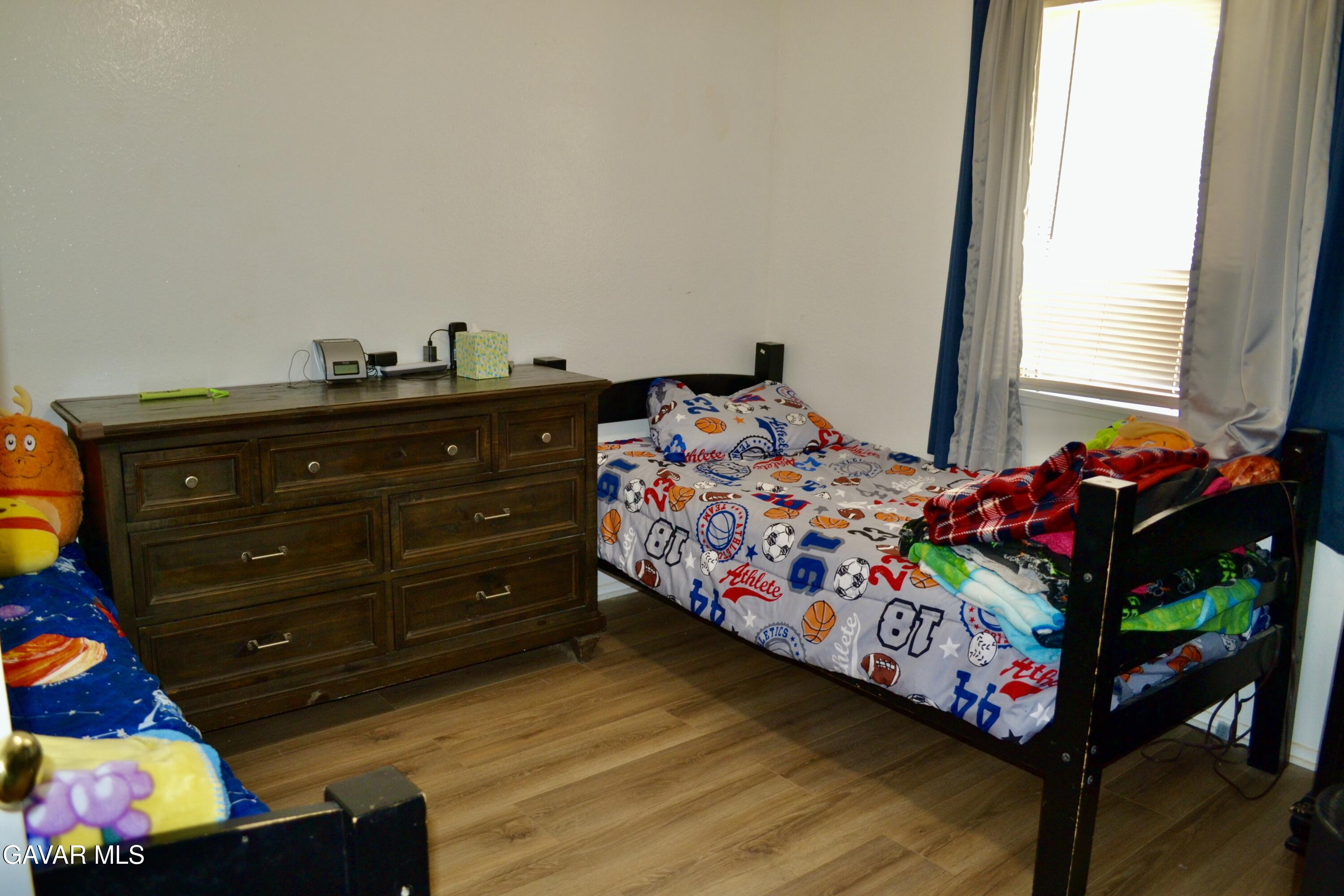 809 South Sunset Street Ridgecrest, CA 93555 - Photo 10 of 21 a bedroom with a bed window and dresser