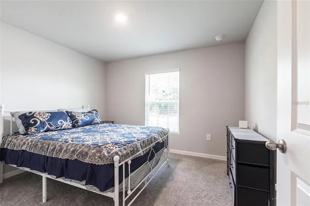 a bedroom with a bed and a lamp