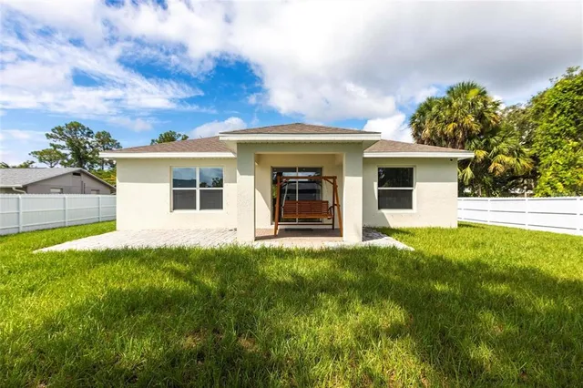 a view of a house with backyard and porch
