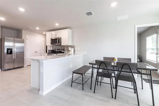 a kitchen with a table and chairs in it