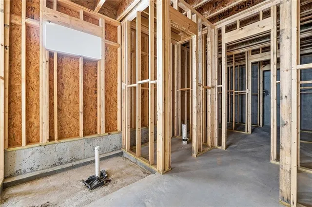 a view of a hallway with wooden floor and entryway