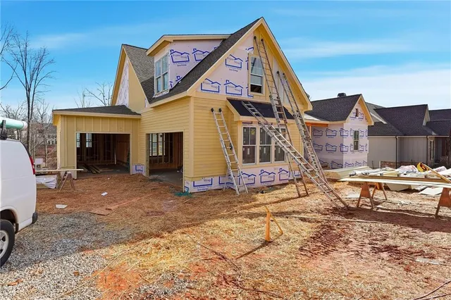 an aerial view of a house with a yard and lake view