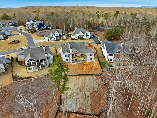 an aerial view of a house with a lake view