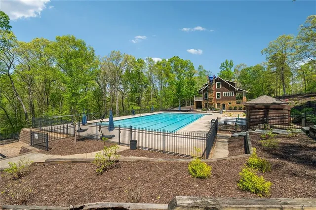 a view of a house with a backyard patio and swimming pool