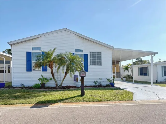 a front view of a house with a garden and plants