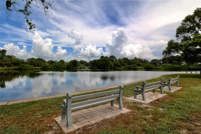 a view of a lake with outdoor seating