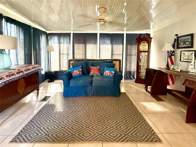 a living room with furniture a rug and a window