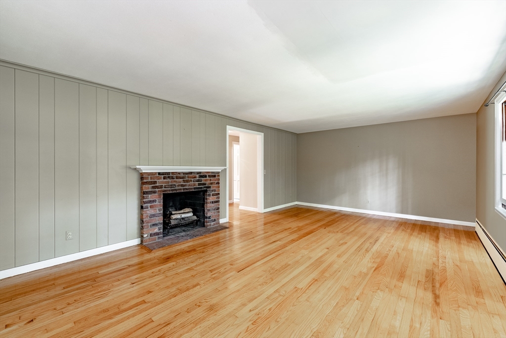 759 Williams Street Longmeadow, MA 01106 - Photo 14 of 40 a view of an empty room with wooden floor fireplace and a window