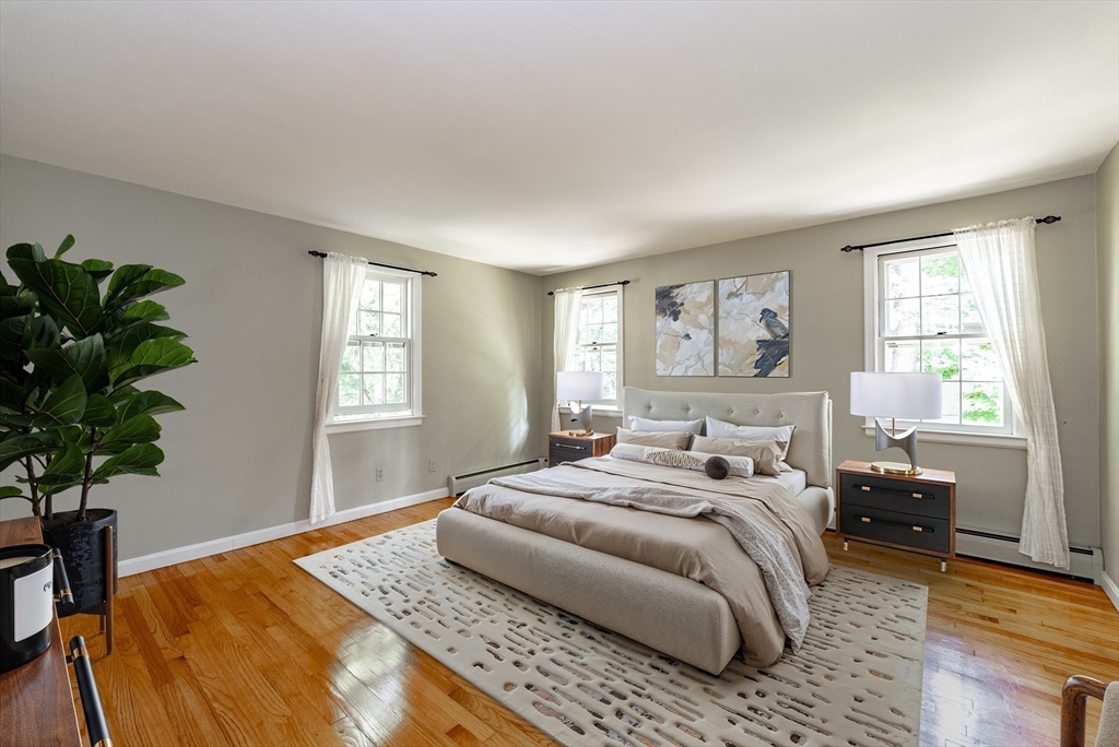 759 Williams Street Longmeadow, MA 01106 - Photo 19 of 40 a bedroom with a bed lamp and a potted plant