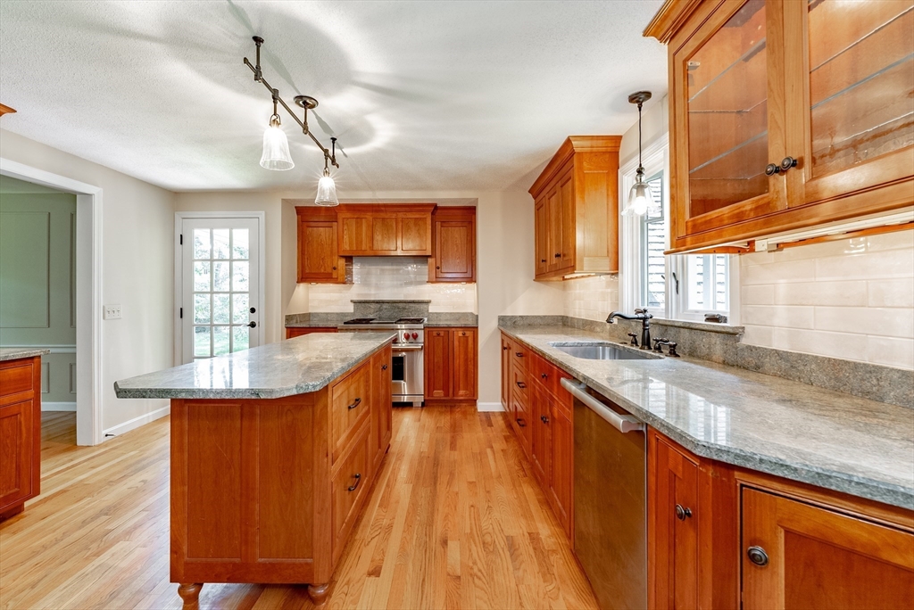 759 Williams Street Longmeadow, MA 01106 - Photo 9 of 40 a large kitchen with stainless steel appliances kitchen island granite countertop a large counter top space a sink a window and cabinets