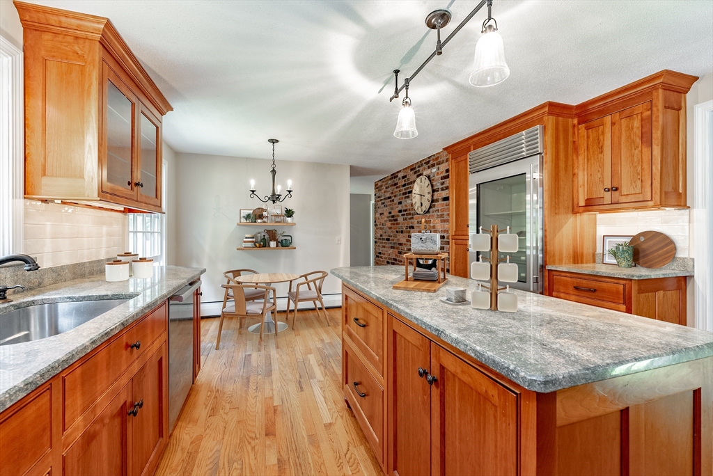 759 Williams Street Longmeadow, MA 01106 - Photo 10 of 40 a kitchen with stainless steel appliances granite countertop a sink dishwasher and cabinets with wooden floor
