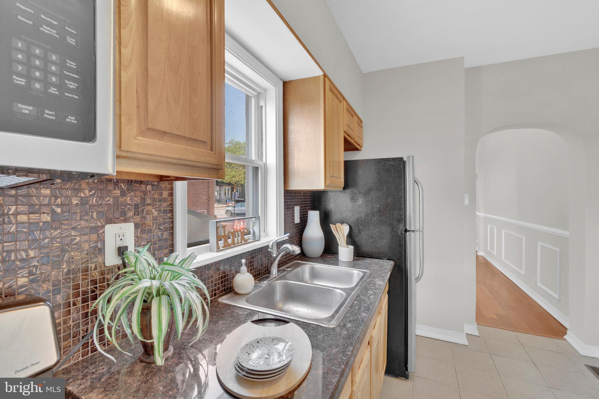 255 South Conkling Street Baltimore, MD 21224 - Photo 16 of 33 a kitchen with sink a table and chairs