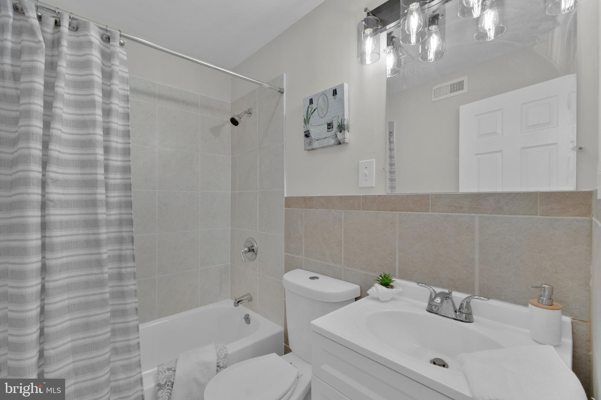 255 South Conkling Street Baltimore, MD 21224 - Photo 20 of 33 a bathroom with a sink a toilet and shower