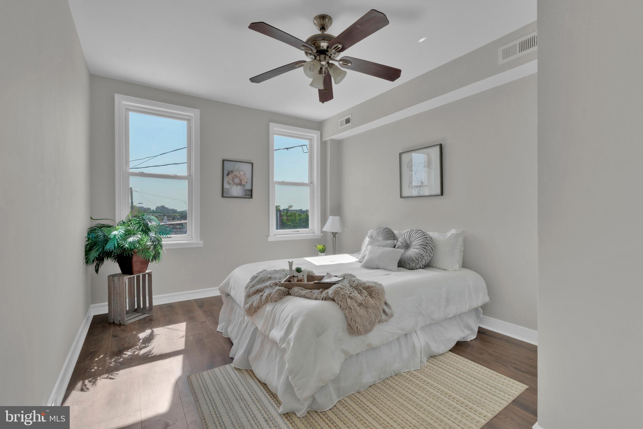 255 South Conkling Street Baltimore, MD 21224 - Photo 21 of 33 a bedroom with a large bed and a chandelier