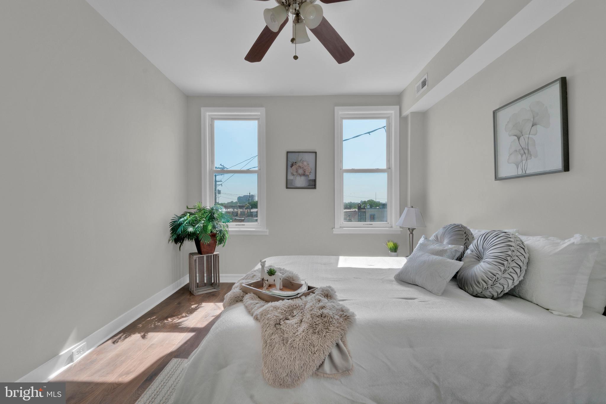 255 South Conkling Street Baltimore, MD 21224 - Photo 23 of 33 a bedroom with a bed and a potted plant