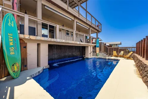 a swimming pool with outdoor seating and yard