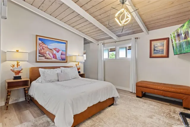 a bedroom with a bed and a chandelier