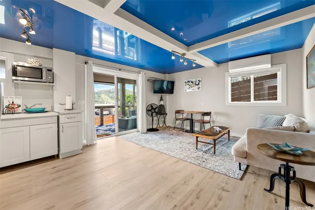 a living room with furniture a wooden floor and a window