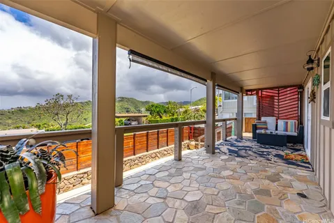 a view of a porch with furniture and front door