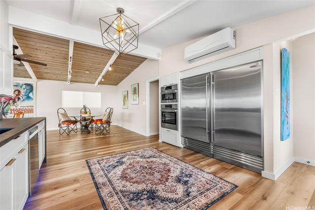 a view of a room with furniture and a chandelier