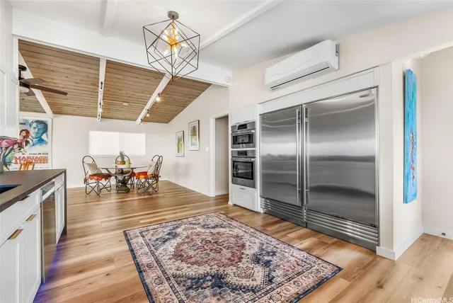 a view of a room with furniture and a chandelier