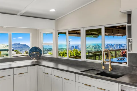 a kitchen with a sink and a large window