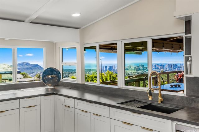 a kitchen with a sink and a large window