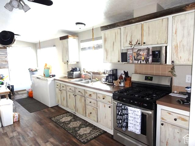 34685 Highway 30 Georgetown, ID 83239 - Photo 5 of 21 Kitchen featuring dark wood-style floors, ceiling fan, stainless steel range with gas cooktop, and a sink