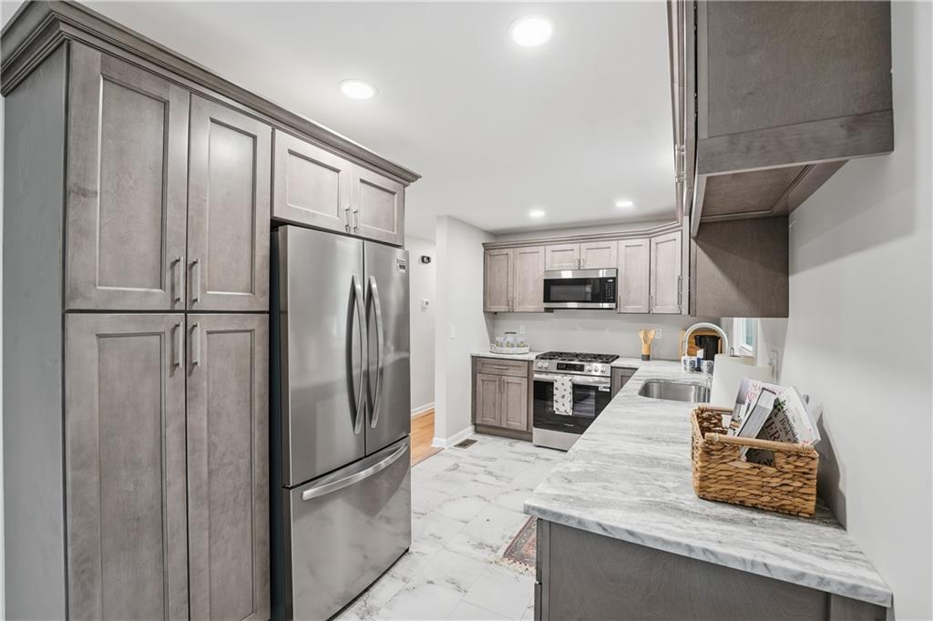 17 Shenango Road New Castle, PA 16105 - Photo 7 of 16 a kitchen with stainless steel appliances granite countertop a refrigerator a stove and a sink