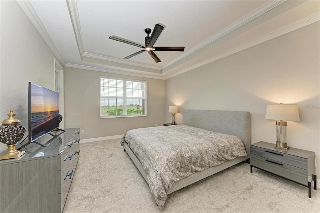 7374 Divot Loop Bradenton, FL 34202 - Photo 15 of 43 a bedroom with a bed and flat screen tv