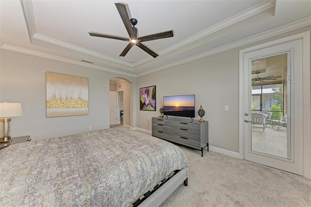7374 Divot Loop Bradenton, FL 34202 - Photo 16 of 43 a bedroom with furniture and a flat screen tv