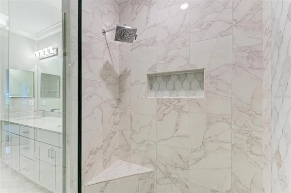 a bathroom with a double vanity sink mirror and shower