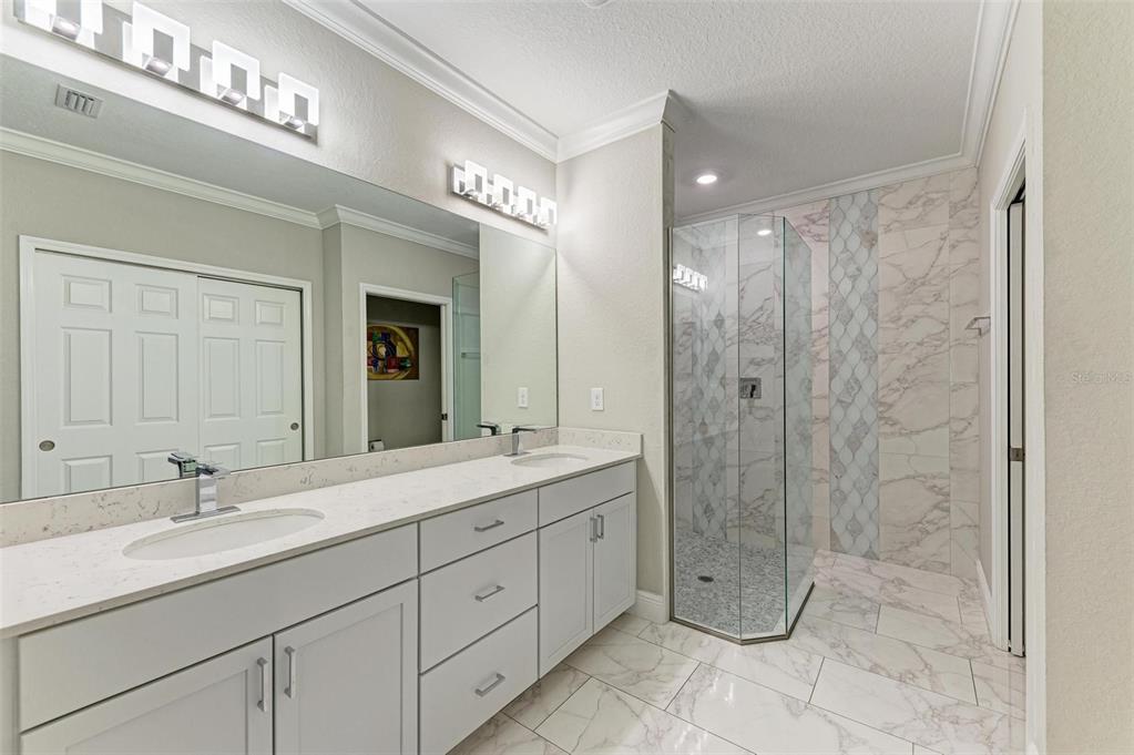 7374 Divot Loop Bradenton, FL 34202 - Photo 18 of 43 a bathroom with a double vanity sink mirror and shower